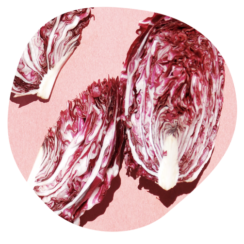 halved red cabbage on purple background